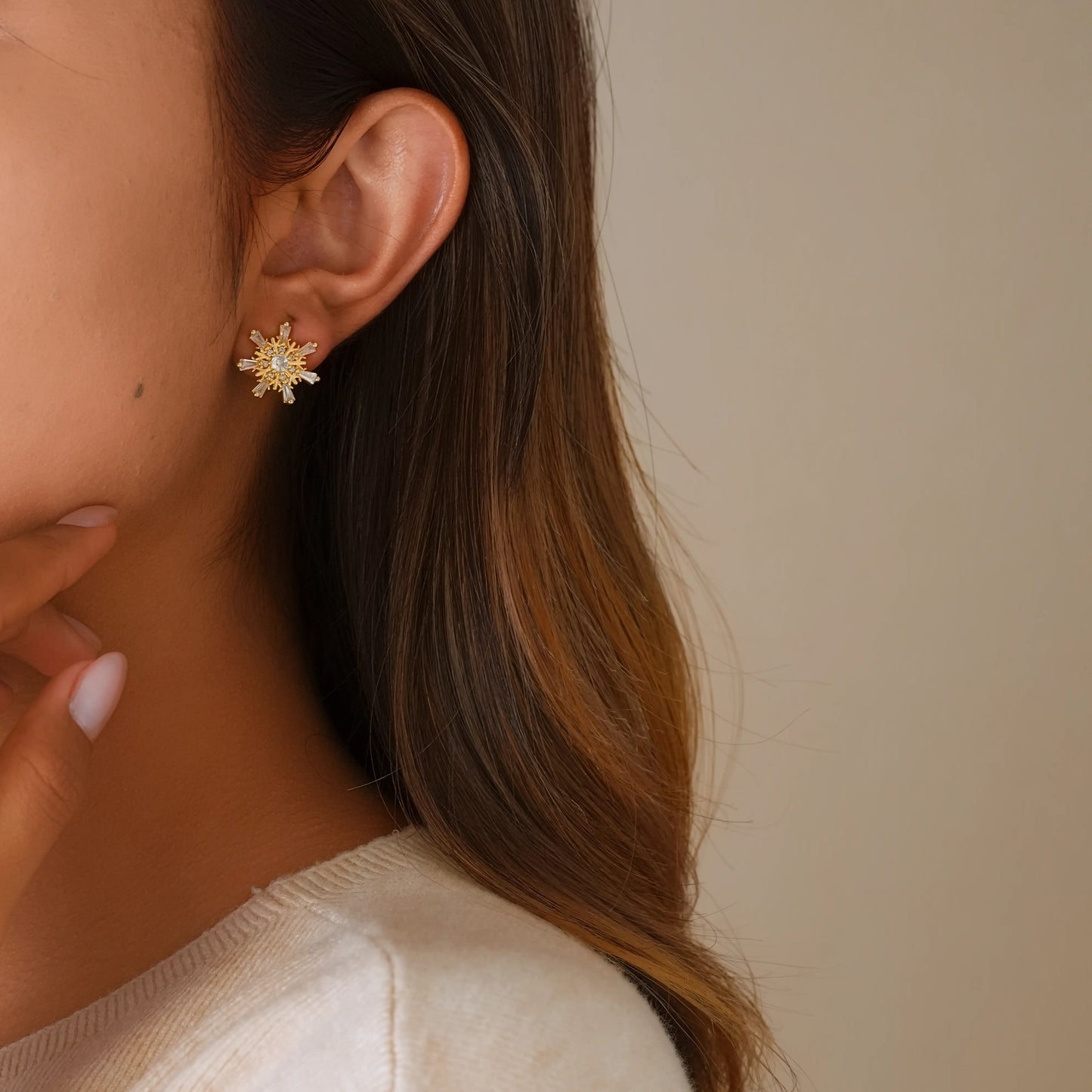 Model wearing gilded frost snowflake clips for a sophisticated winter holiday look.