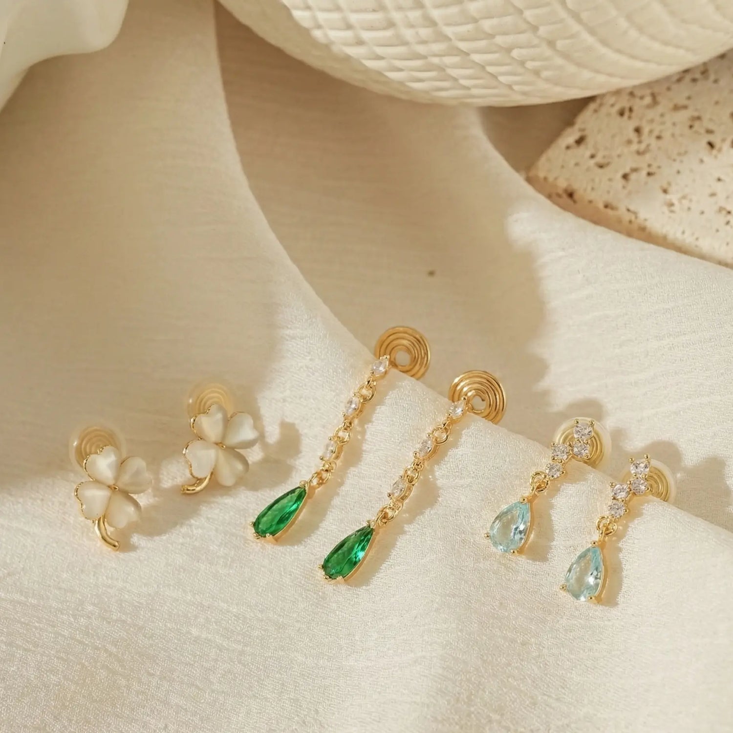 A colorful array of birthstone clip-on earrings for unpierced ears, featuring aquamarine and moonstone gems