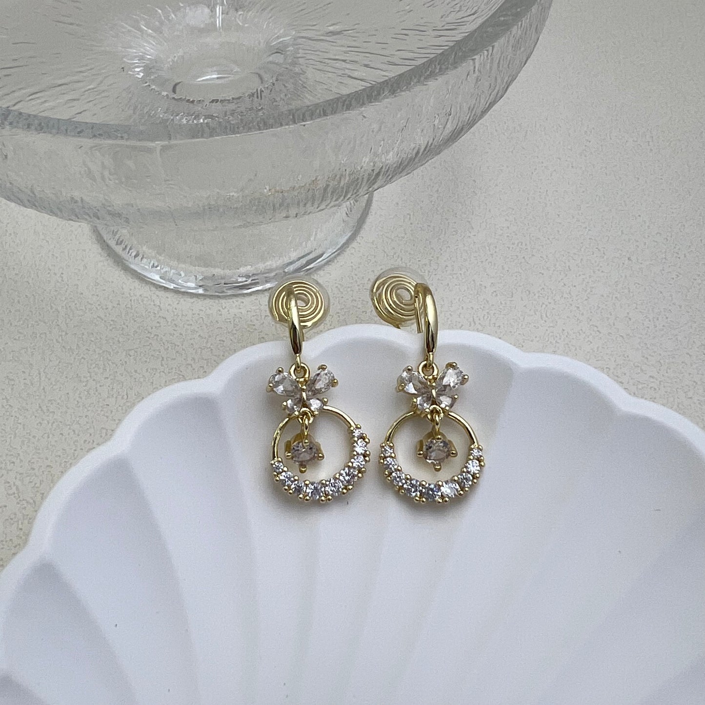 Pair of gold Diamond Butterfly Dangle Earrings on a white background, featuring sparkling rhinestone wings and long chain fringe.