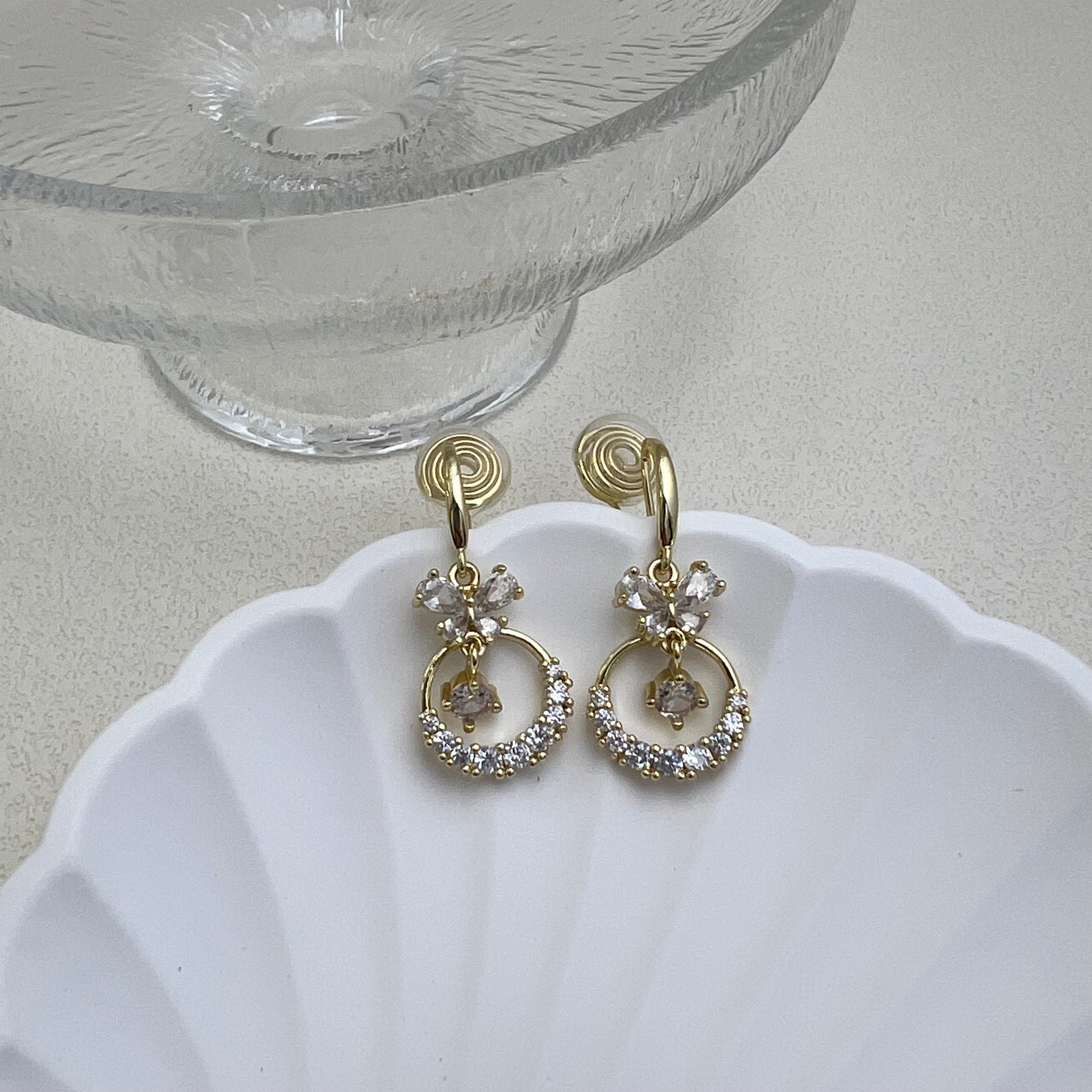 Pair of gold Diamond Butterfly Dangle Earrings on a white background, featuring sparkling rhinestone wings and long chain fringe.