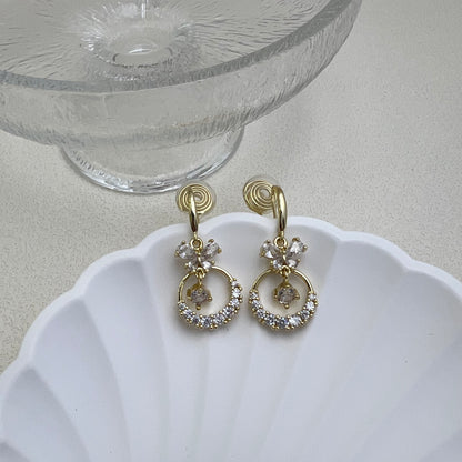 Pair of gold Diamond Butterfly Dangle Earrings on a white background, featuring sparkling rhinestone wings and long chain fringe.