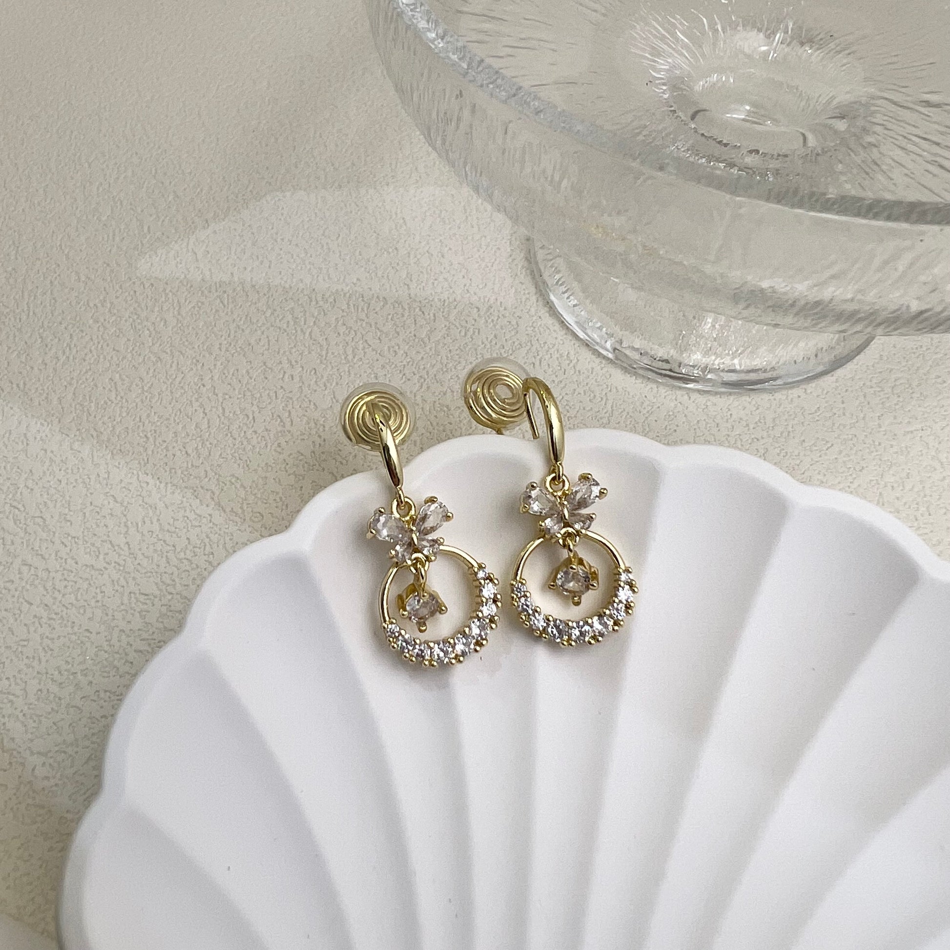 Detail shot of the clear adjustable resin clip mechanism on the Diamond Butterfly Dangle Earrings, designed for pain-free wear.