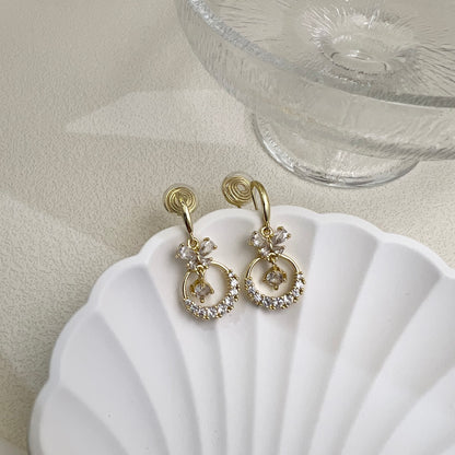 Detail shot of the clear adjustable resin clip mechanism on the Diamond Butterfly Dangle Earrings, designed for pain-free wear.