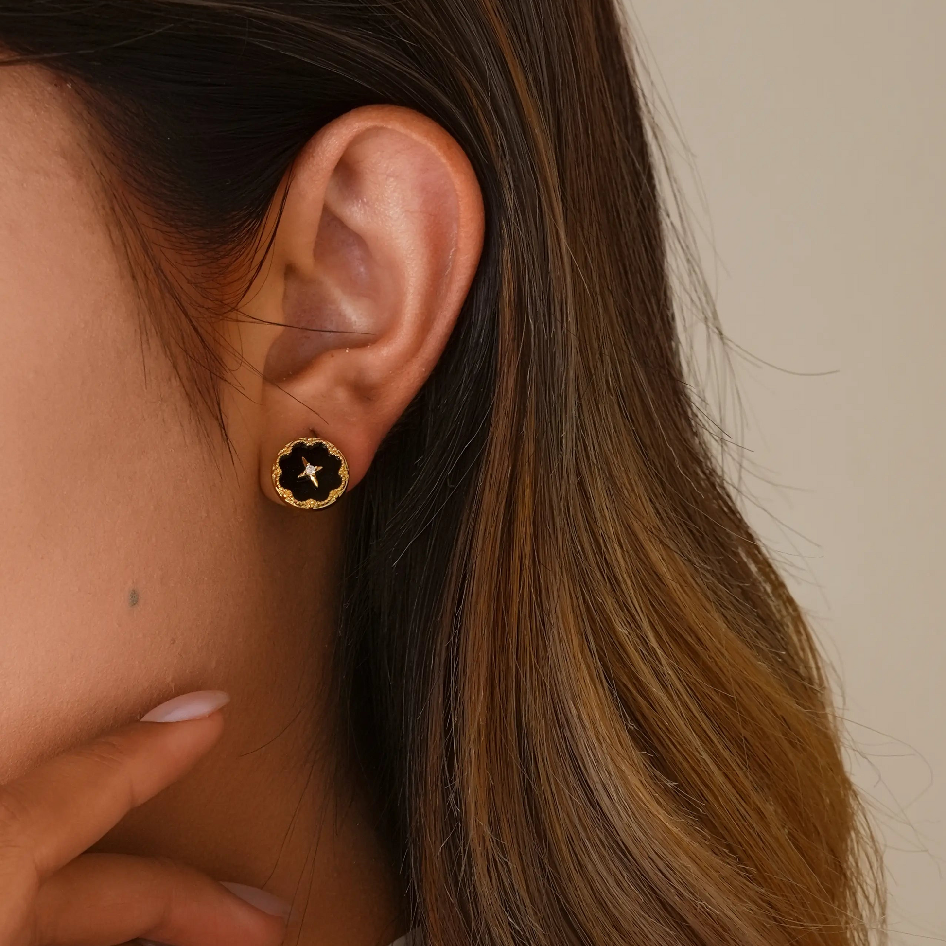 Close-up of model styling the celestial noir clips, showing the realistic "pierced" fit.