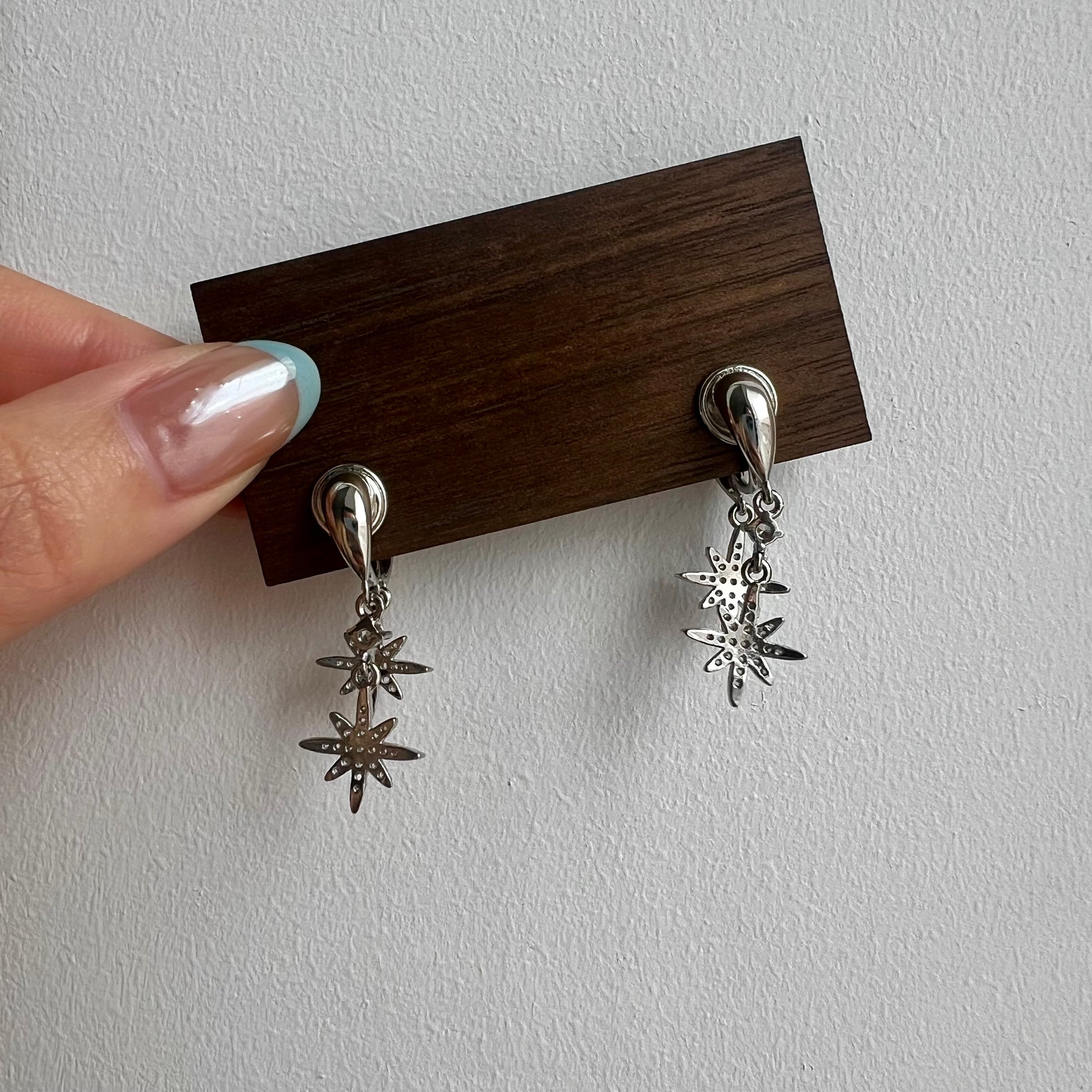 Close-up of the comfortable, pinch-free clip-on back mechanism on a silver star drop earring