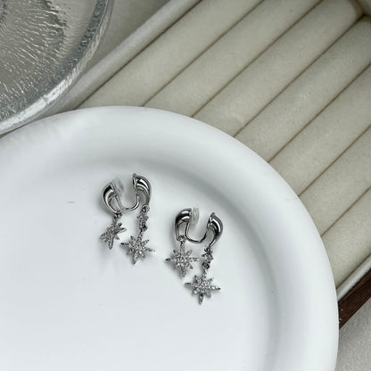 Side profile of a model wearing a silver front-to-back star drop clip-on earring, showing the floating celestial design