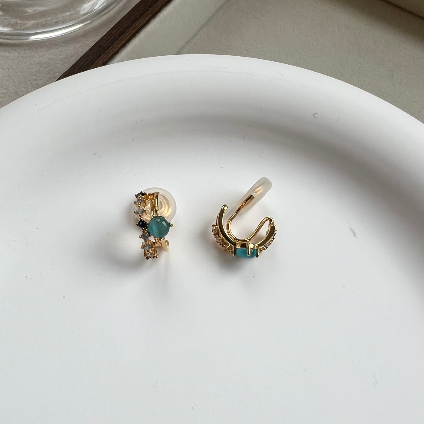 Side view of a mini gold double hoop earring showing the comfort clip and illusion of double piercing 