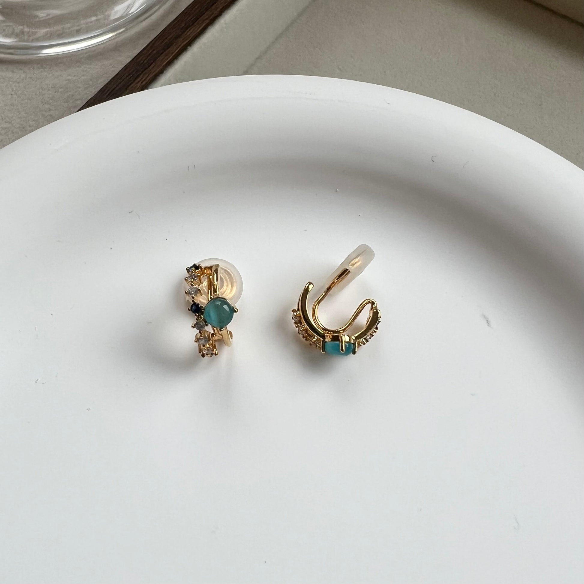 Side view of a mini gold double hoop earring showing the comfort clip and illusion of double piercing 