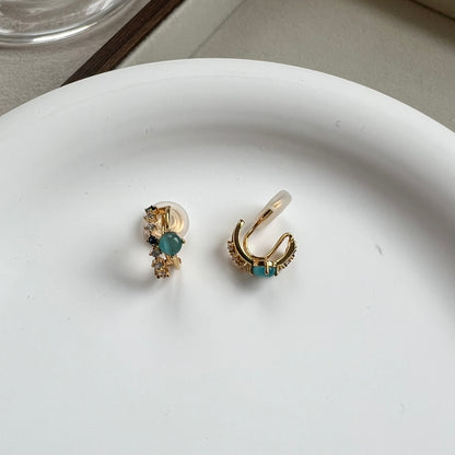 Side view of a mini gold double hoop earring showing the comfort clip and illusion of double piercing 