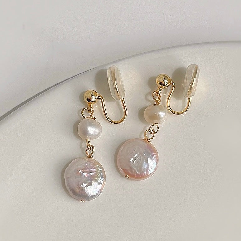 Close-up shot highlighting the organic, natural texture of the freshwater coin pearl and the polished gold-tone connecting links.