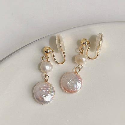 Close-up shot highlighting the organic, natural texture of the freshwater coin pearl and the polished gold-tone connecting links.