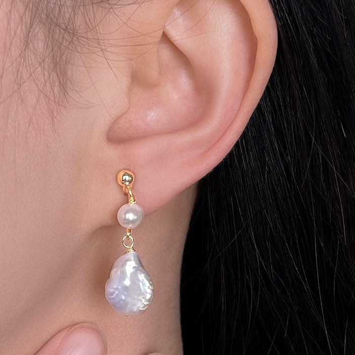 Model wearing the double freshwater pearl drop clip-on earrings, showcasing the elegant dangle length and comfortable non-pierced fit.