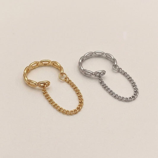 A pair of chain link ear cuffs with delicate draped chain loops shown side-by-side in high-shine gold and silver finishes on a neutral background.