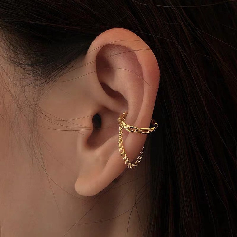 Model wearing the draped chain link ear cuff positioned on the upper cartilage, paired with everyday studs.