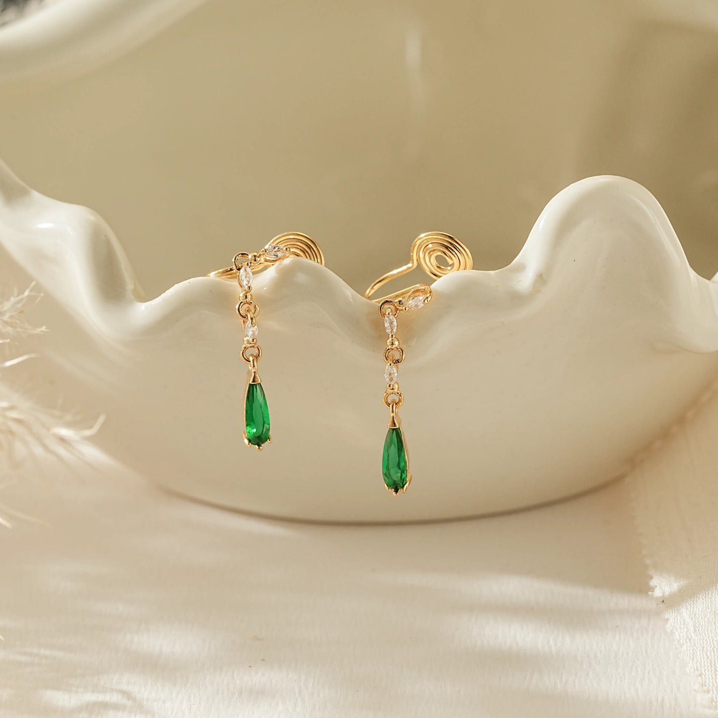 May birthstone emerald green teardrop clip-on earrings in 18k gold.