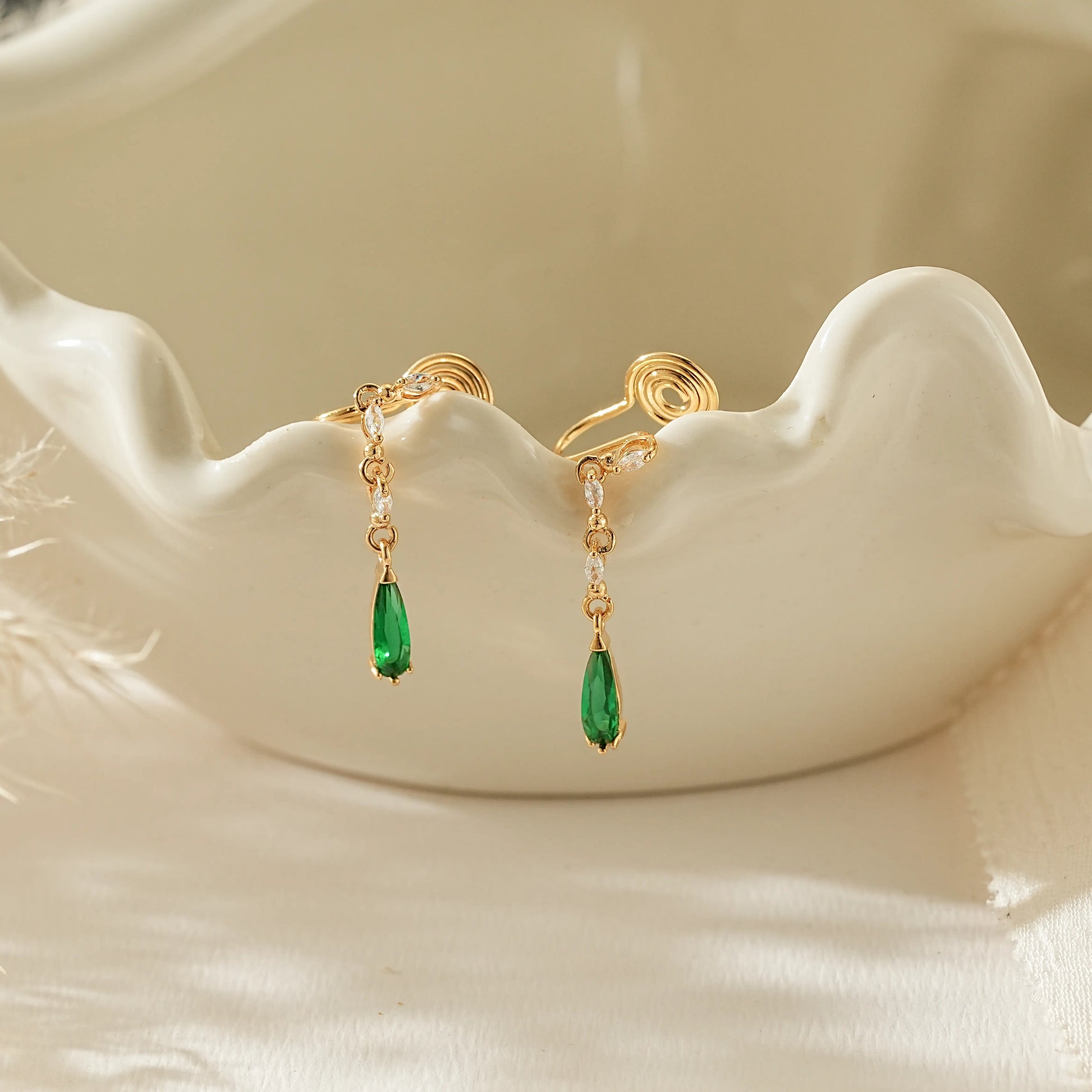 May birthstone emerald green teardrop clip-on earrings in 18k gold.