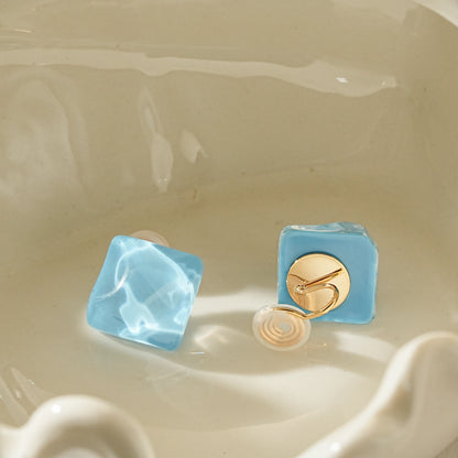 Back view showing the adjustable, pinch-free clip-on back on geometric glass earrings.