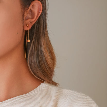 Model wearing gold threader illusion clips, showcasing a modern, elongated ear stack