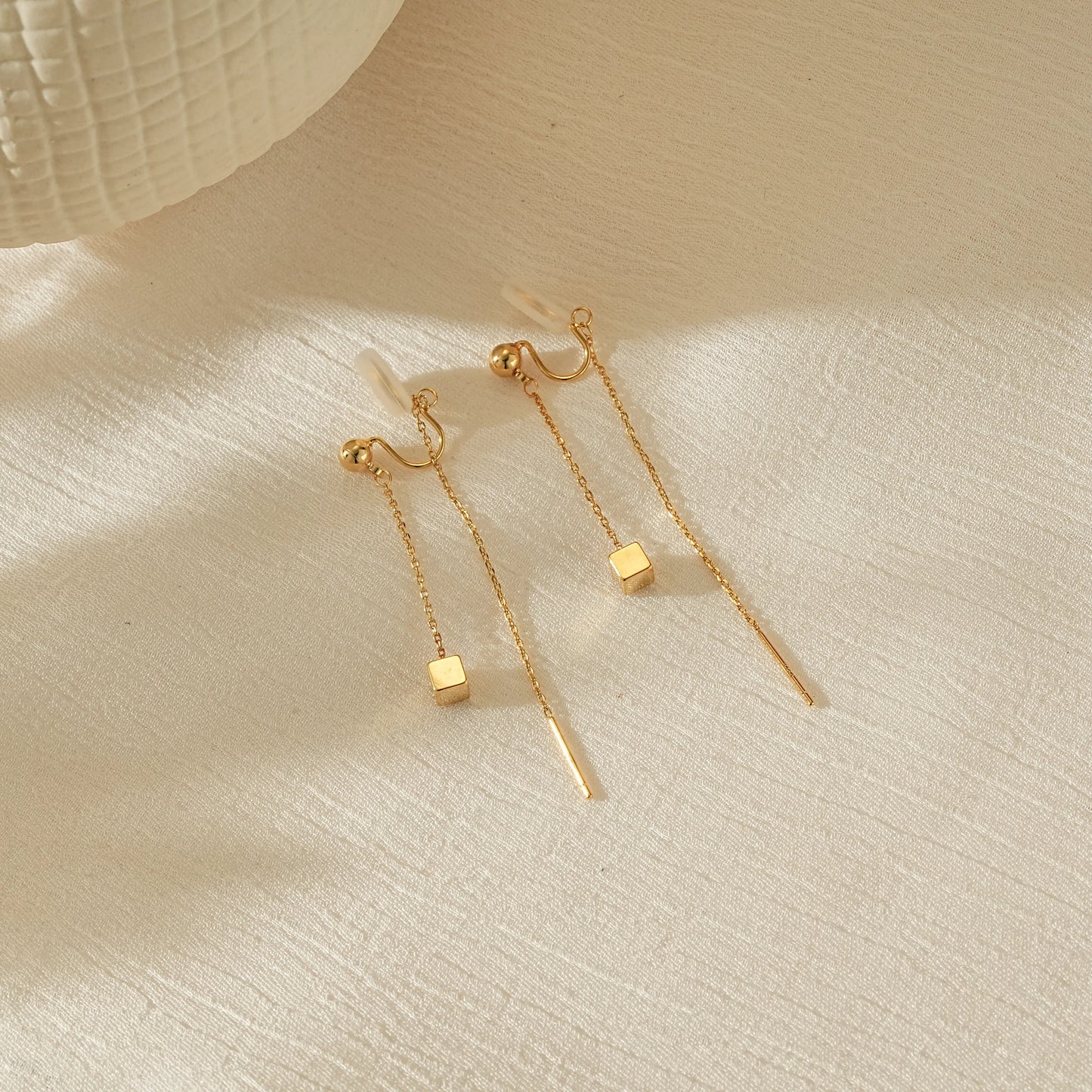 Side view of gold long chain earrings showing the adjustable, secure clip-on anchor.
