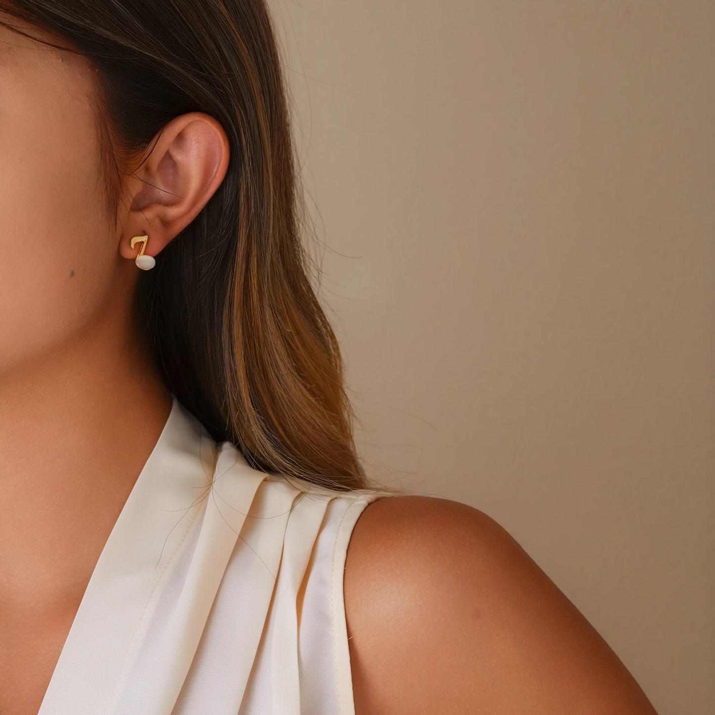 Model wearing the gold music note clip-ons for a creative and elegant look.