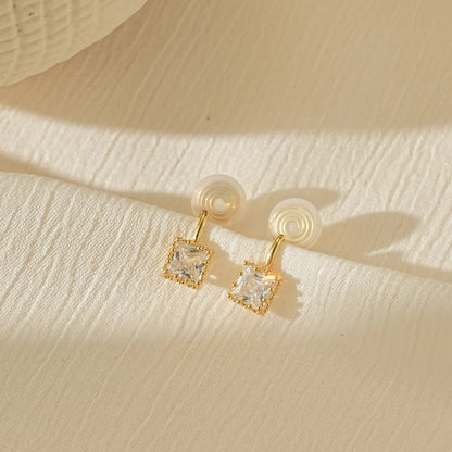 Macro close-up of the square princess cut CZ stone set in polished gold.