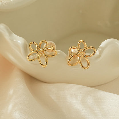 Close-up of the hand-twisted gold wire petal detail on minimalist clip-on earrings.