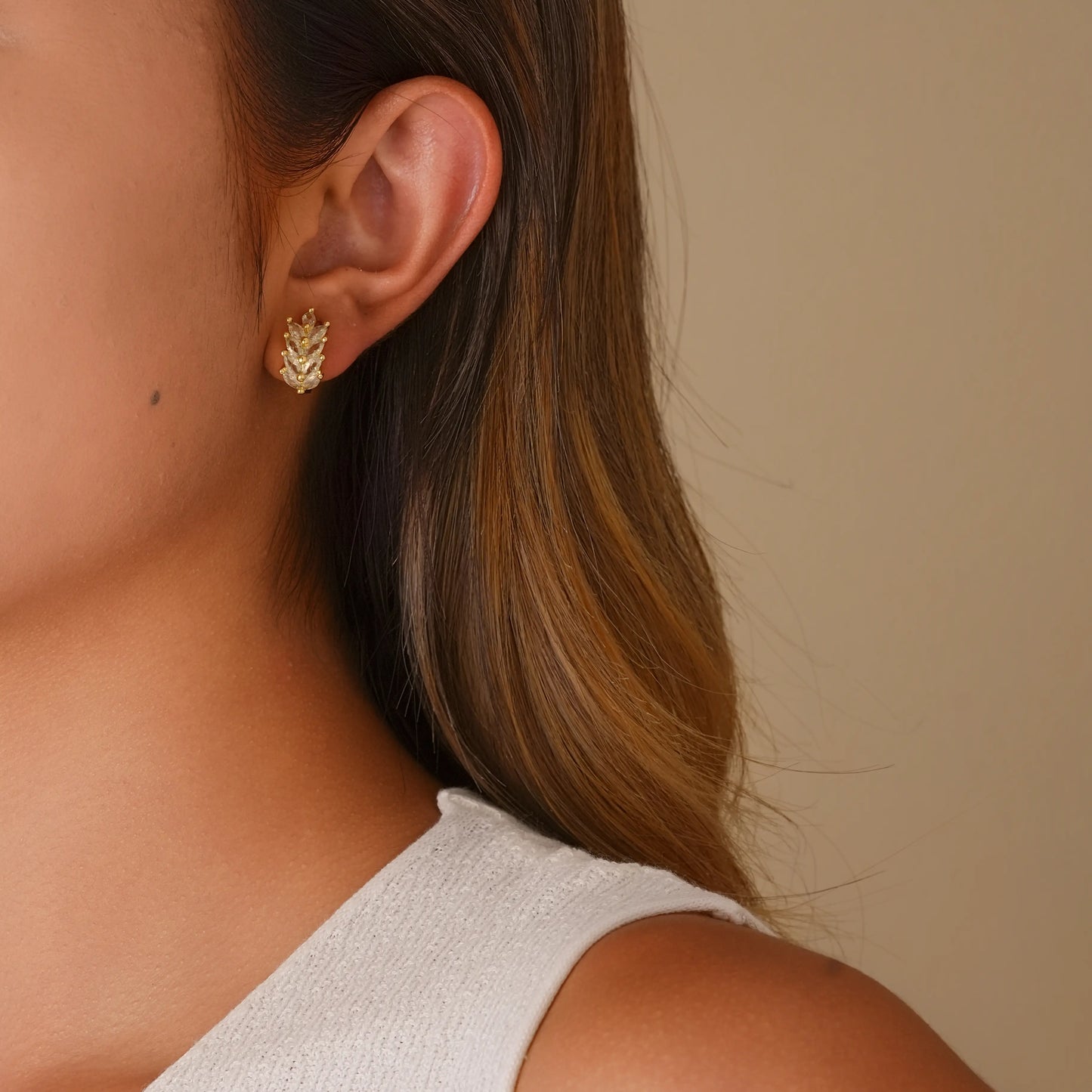 Model wearing the gold wheat diamond clip-ons for an elegant, non-pierced look.