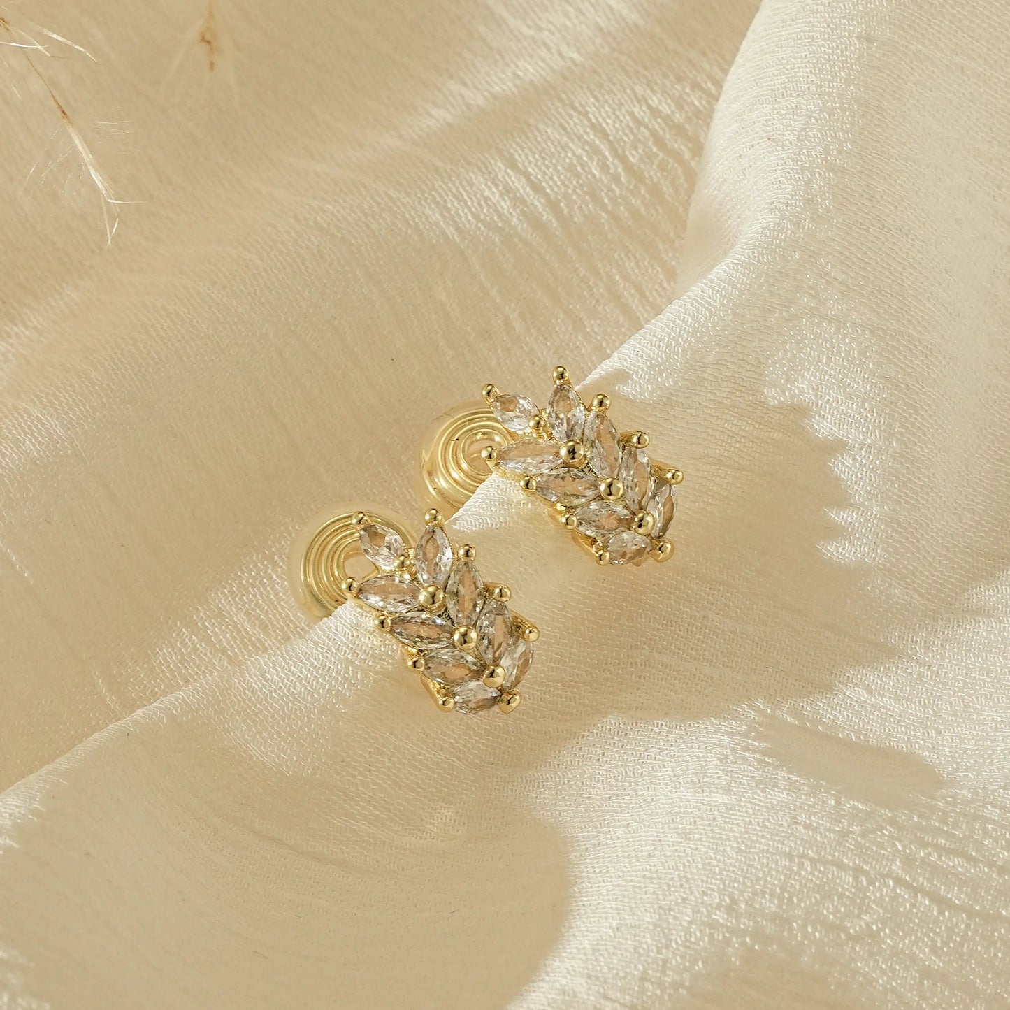 Gold wheat diamond clip-on earrings in 18k gold plating, front view.