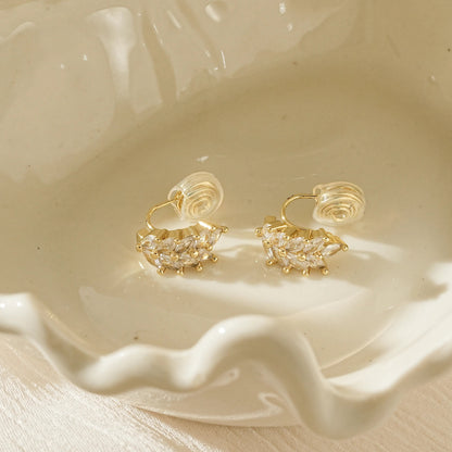 Close-up of CZ diamonds on the gold wheat-shaped clip-on studs.