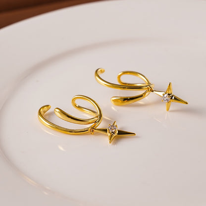 Model wearing a gold double hoop illusion clip-on earring with a North Star drop, demonstrating a seamless multi-pierced look on an unpierced ear.