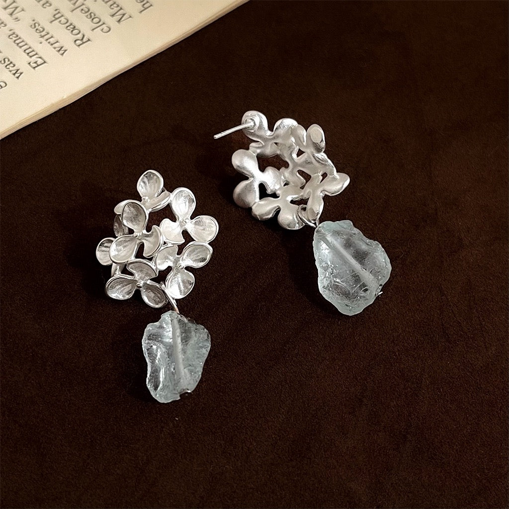 Close-up comparison of the pierced stud post and invisible clip-on options for the silver floral blue crystal drop earrings.