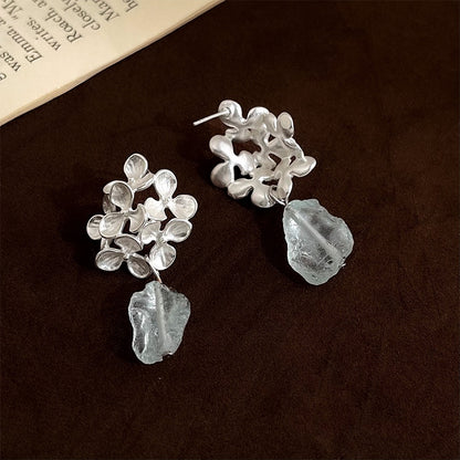 Close-up comparison of the pierced stud post and invisible clip-on options for the silver floral blue crystal drop earrings.