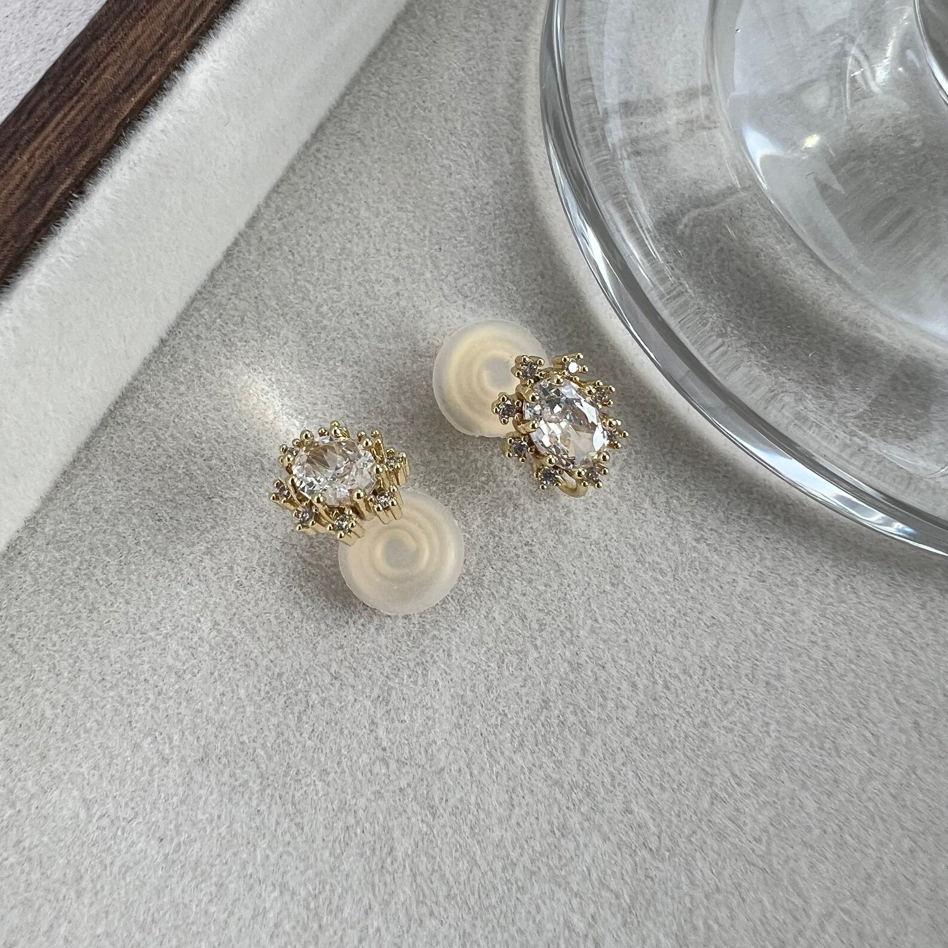 Angled macro shot of oval diamond stimulant studs capturing light reflection and facets