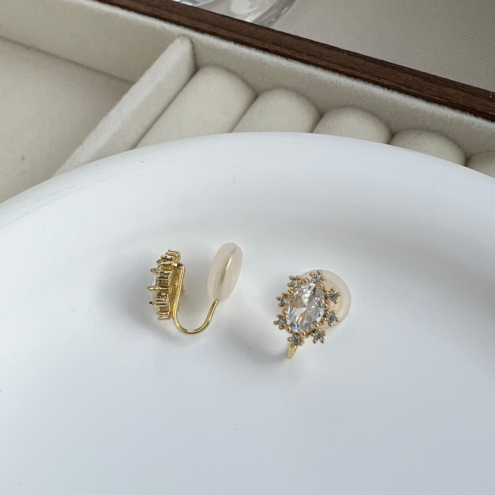 Oval cubic zirconia clip-on earrings displayed inside jewelry gift tray