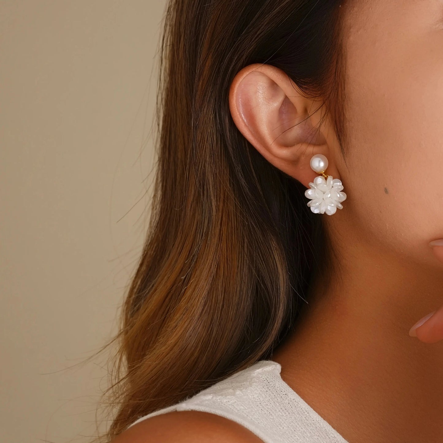 Close-up of model styling the floral pearl clips, showing the comfortable, secure fit.