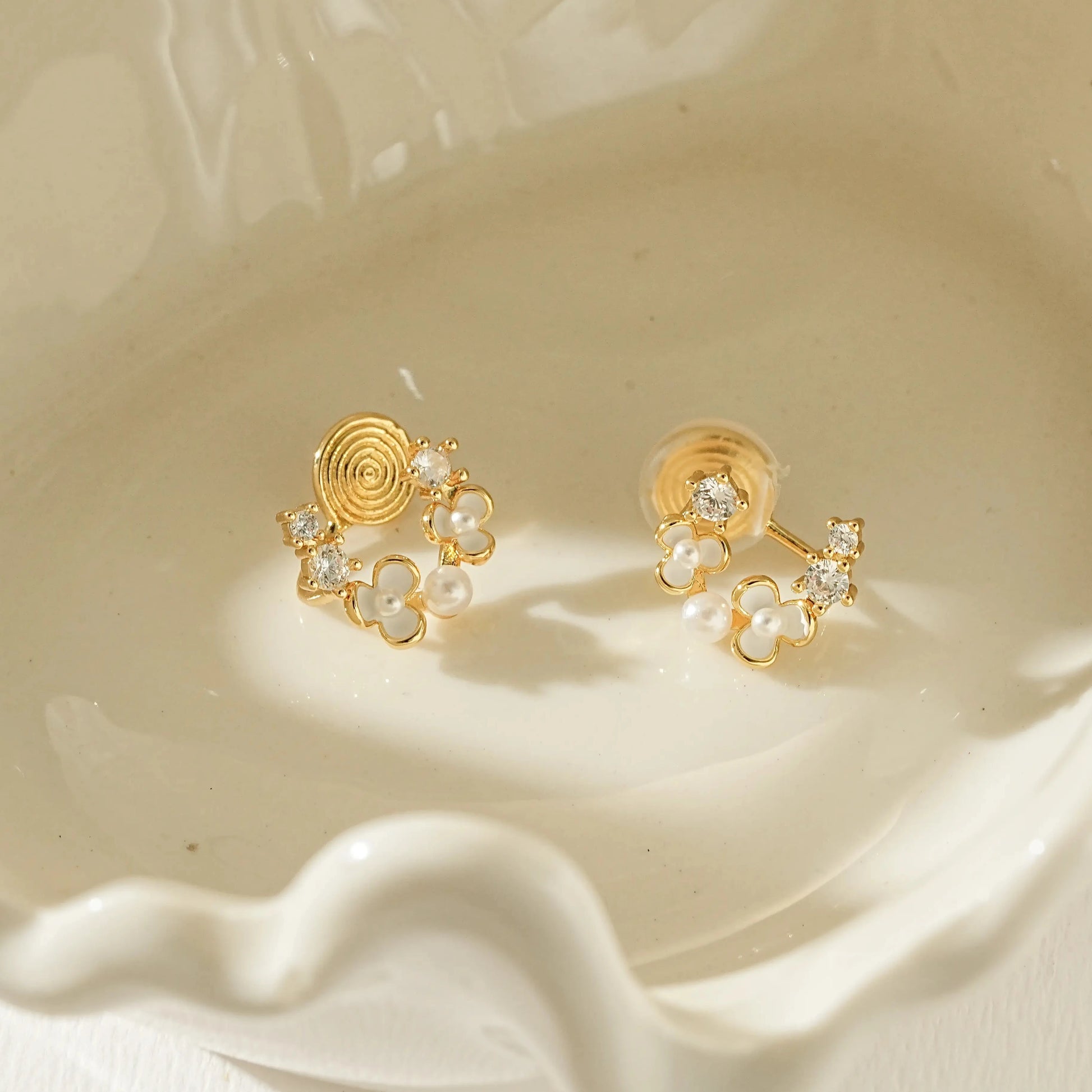 Close-up of the dainty gold flower petal and petite pearl center detail.