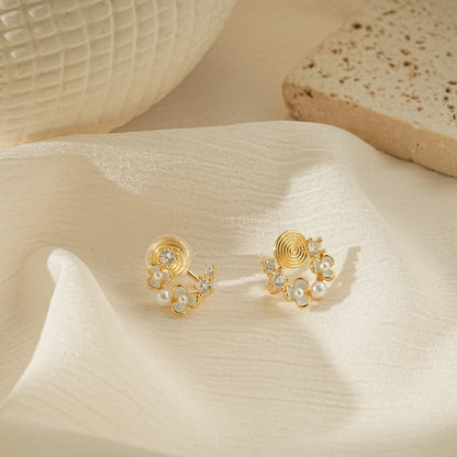 Minimalist pearl flower earrings for unpierced ears on a soft, creamy background.