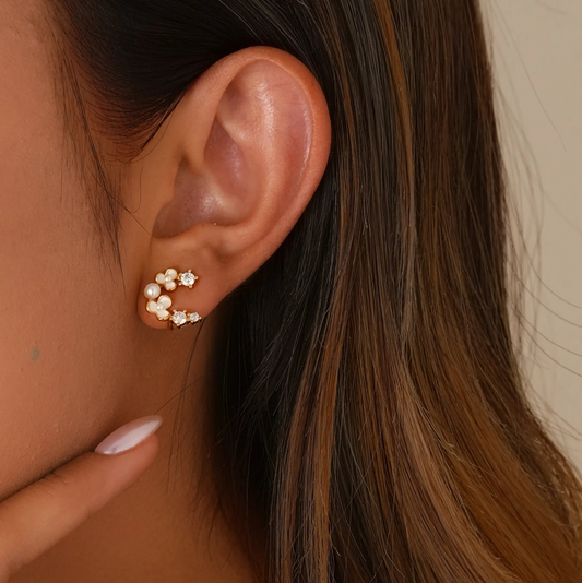 Close-up of model styling the tiny floral clips, showing a realistic "pierced" stud fit.