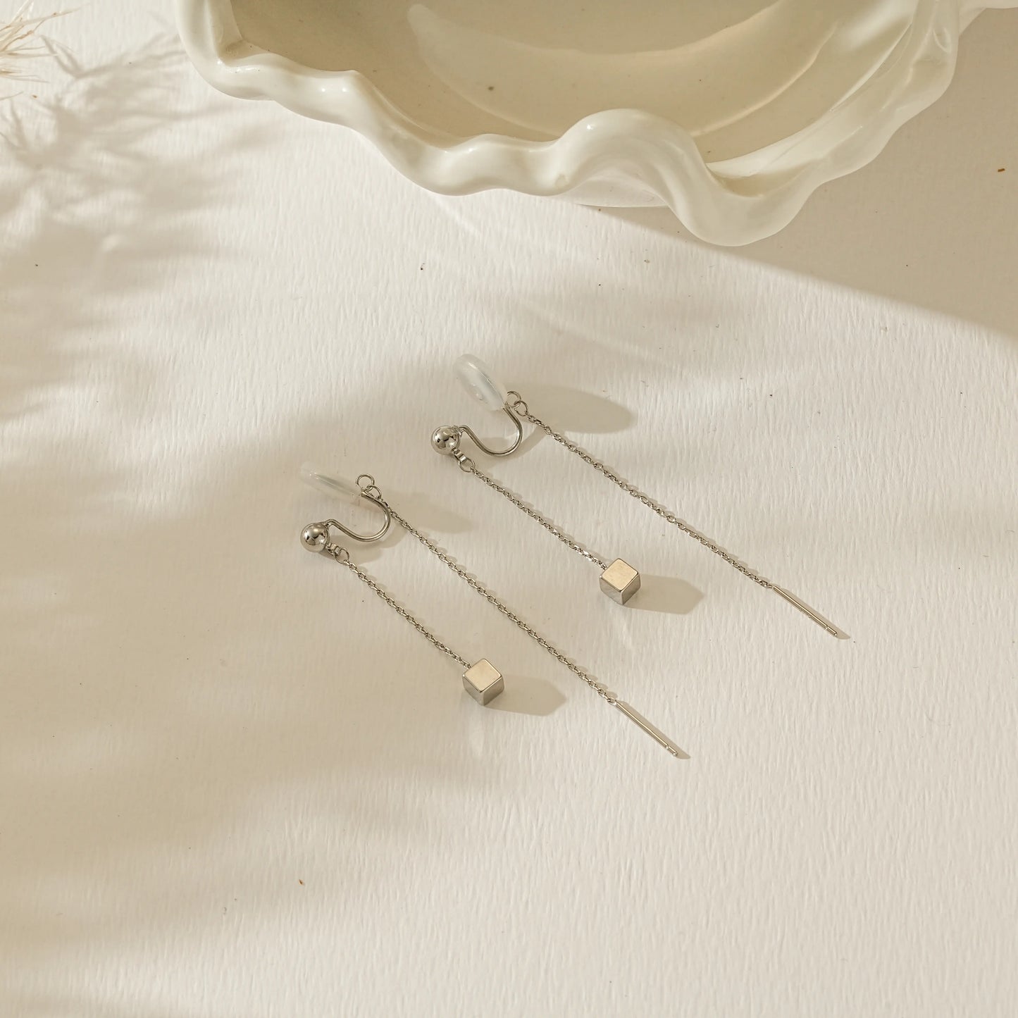 Side view of silver long chain clip-ons illustrating the lightweight, pinch-free fit.