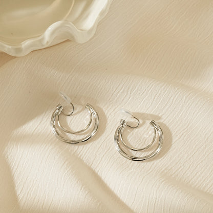 Side view of silver double hoops illustrating the lightweight, hollowed-out structure.