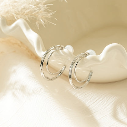 Polished silver chunky half moon double hoop clip-on earrings.