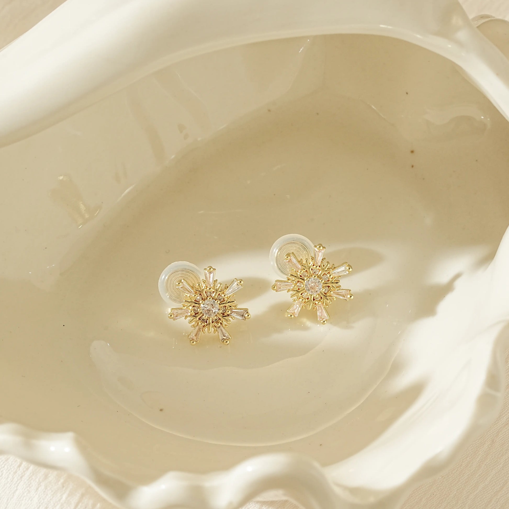 Gold snowflake diamond stud clip-on earrings in 18k gold plating.