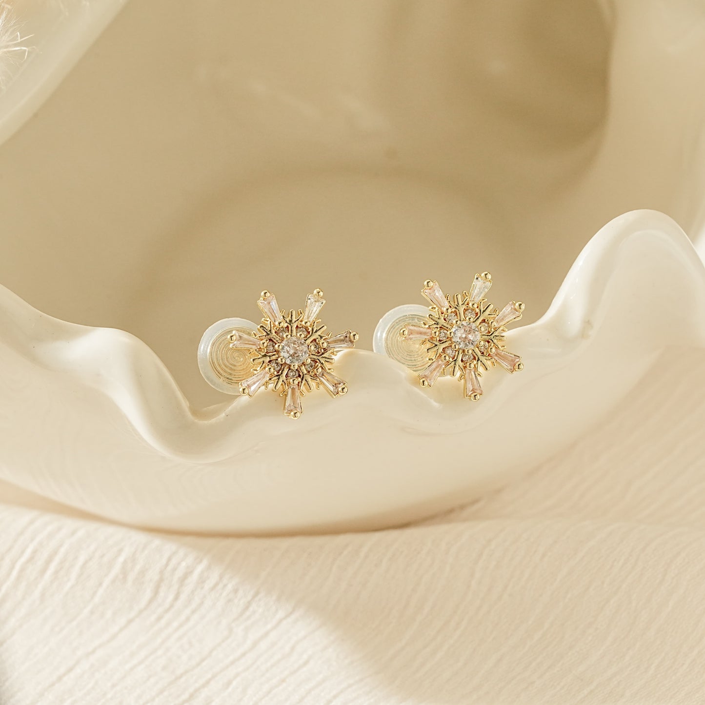 Close-up of the intricate gold snowflake design with sparkling CZ diamond accents.