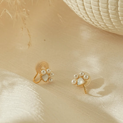 Tiny paw print pearl clip-on earrings in 18k gold plating, front view.