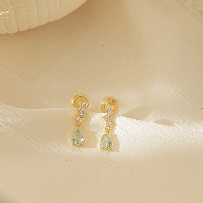 Pair of Aquamarine blue dangle drop clip-on earrings with gold settings, an elegant choice for non-pierced jewelry.