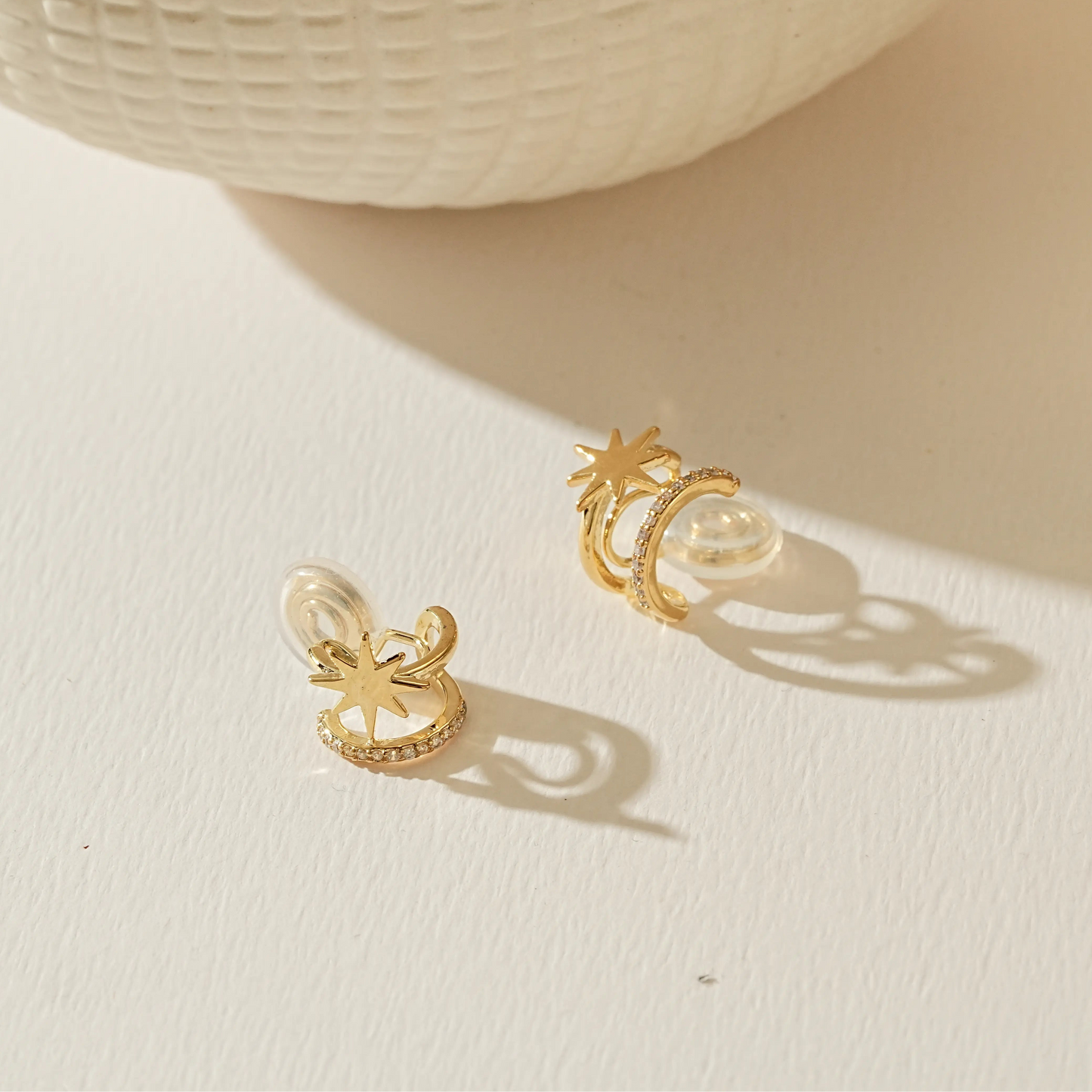 Side view of 18k gold plated double star hoop earrings showing the adjustable clip.