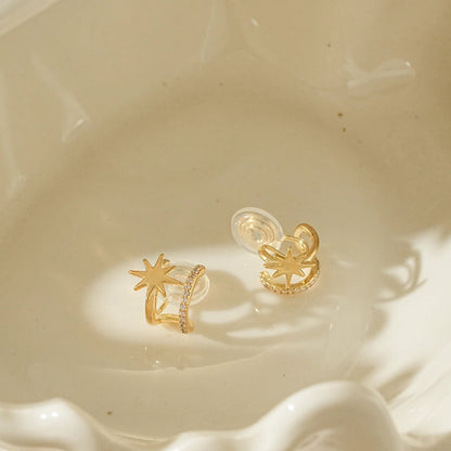Close-up of adjustable gold star clip-on hoops for unpierced ears.