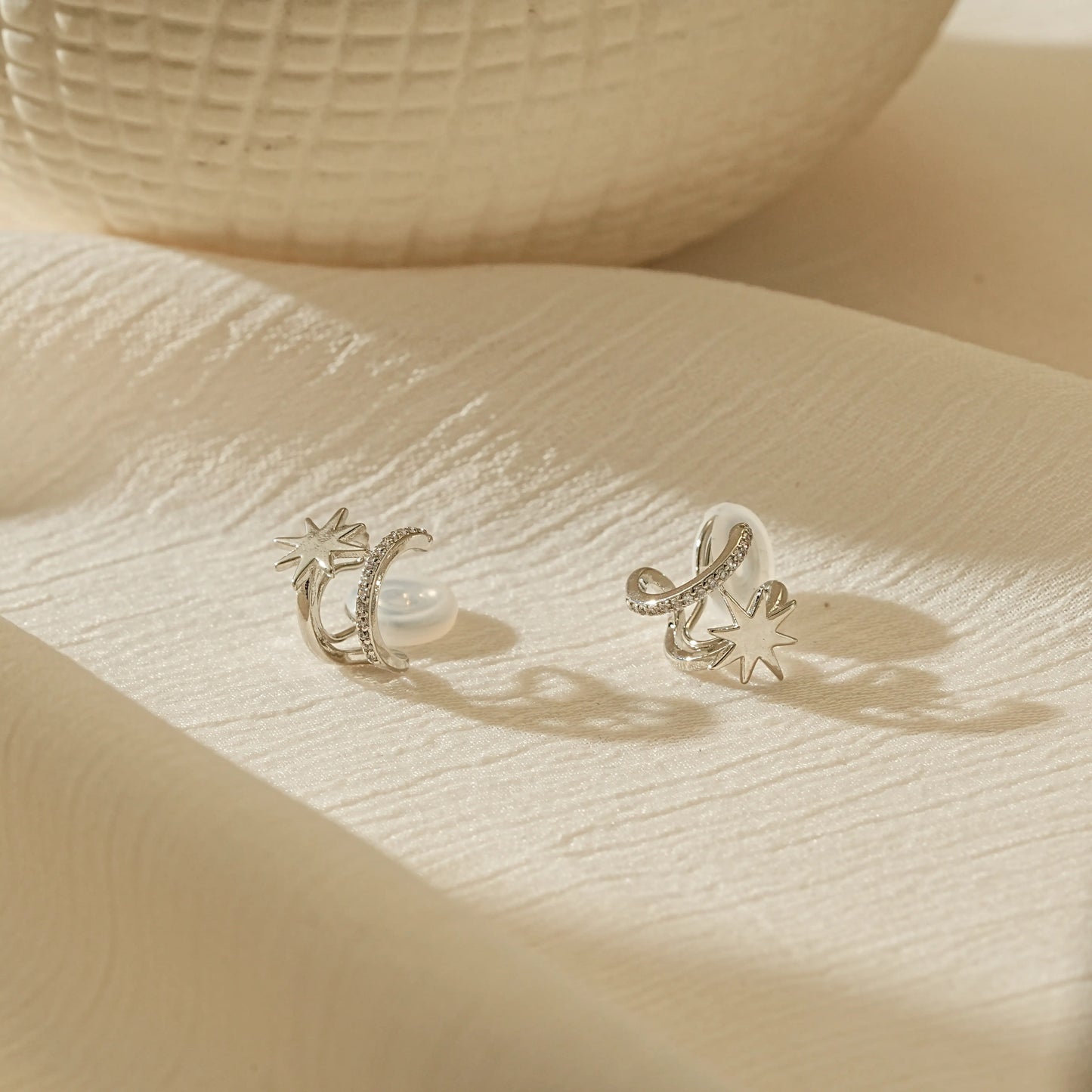 Minimalist silver double hoop star earrings for unpierced ears, high-shine finish.